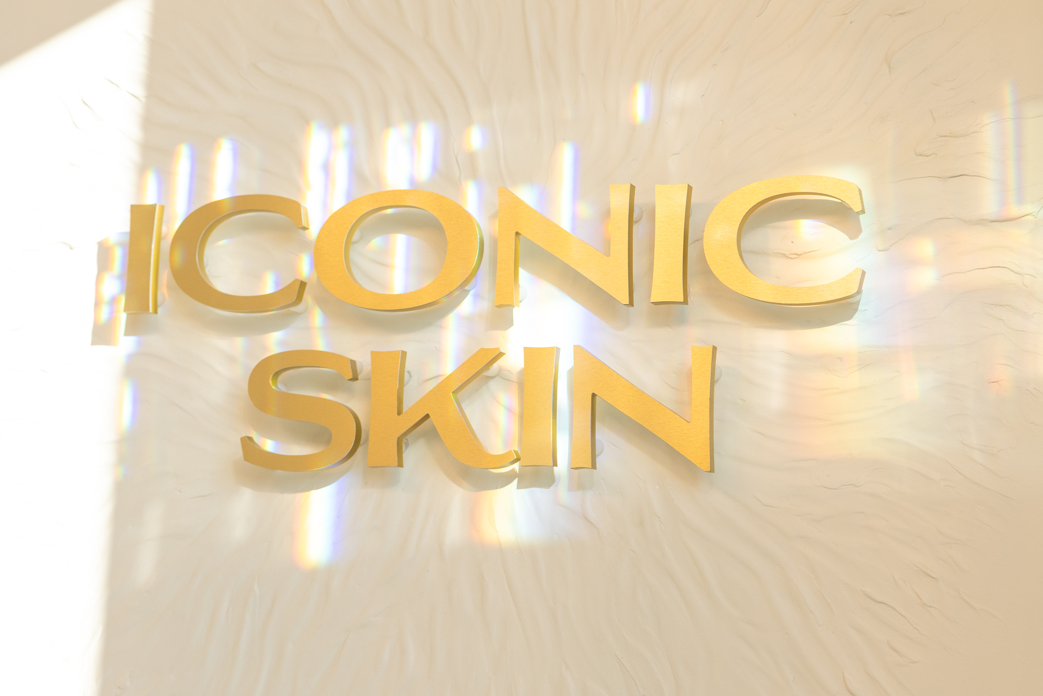 Gold Iconic Skin signage inside the Sugar House boutique